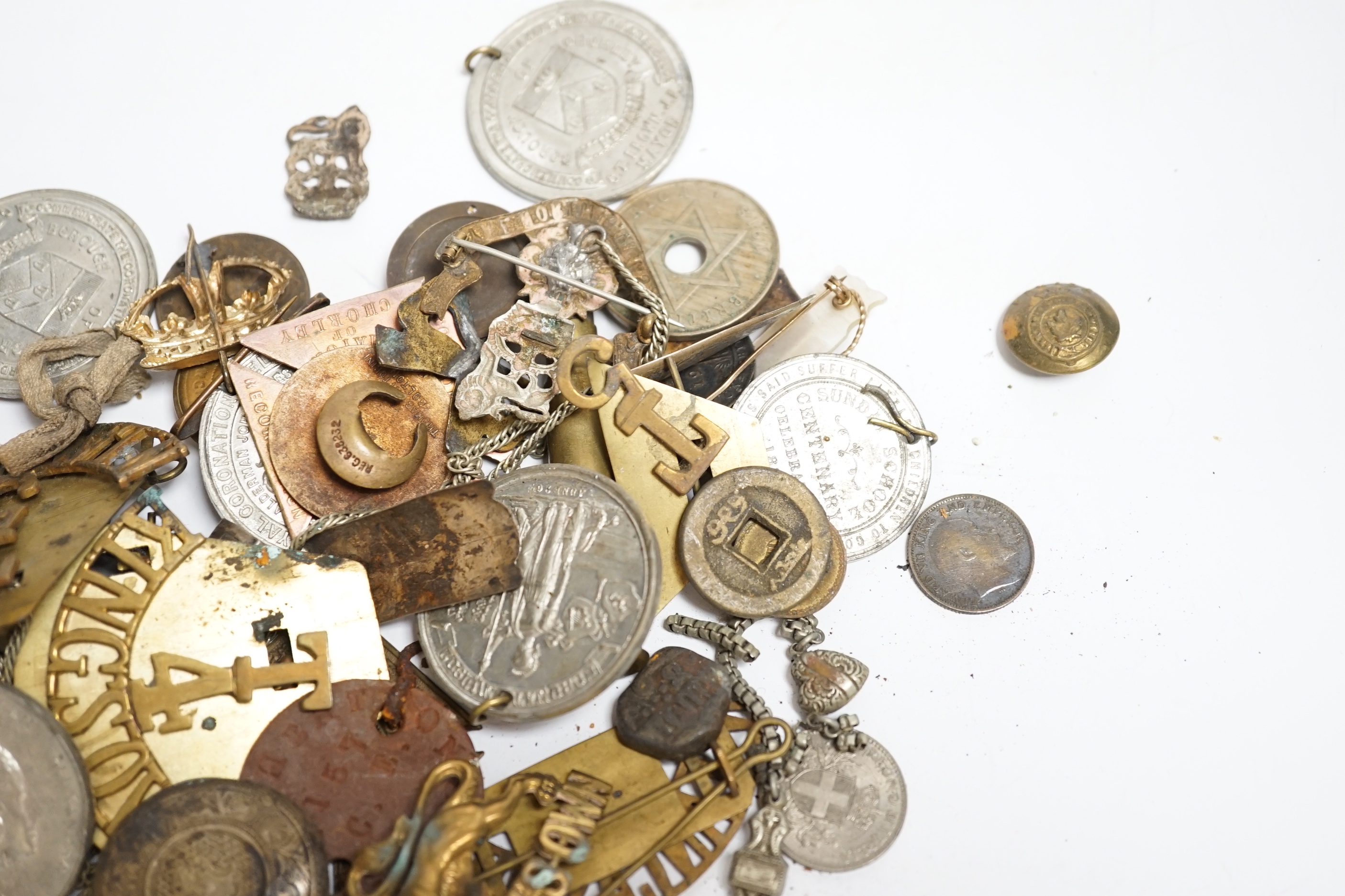 A quantity of military cap badges, etc.